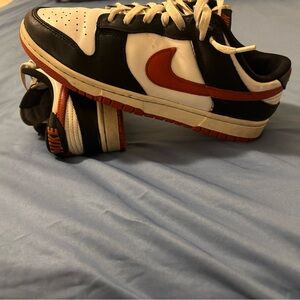 Nike Black and White Shoes with Orange Swoosh